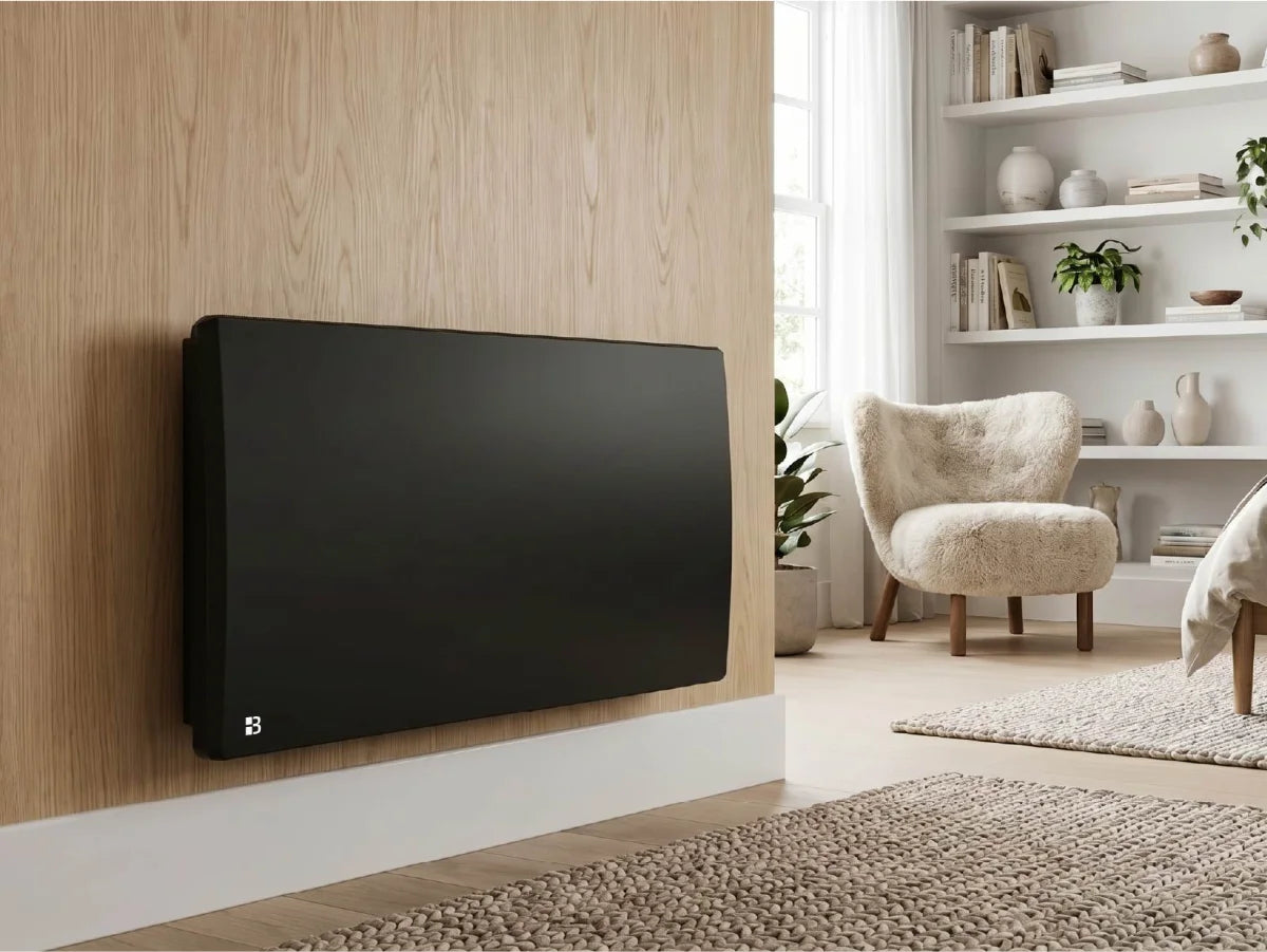 ARIA BLACK ceramic dry inertia radiator in a modern, bright living room