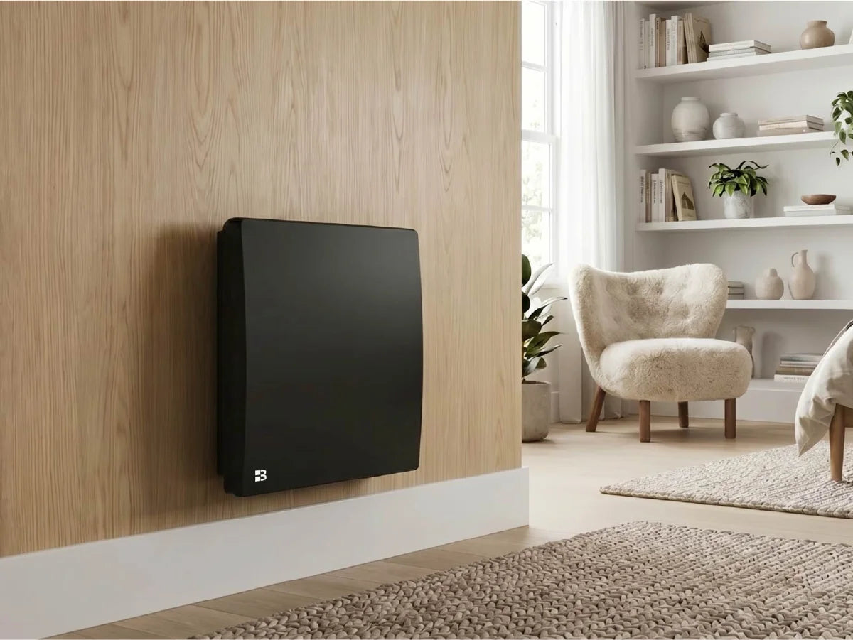ARIA BLACK ceramic dry inertia radiator in a modern, bright living room