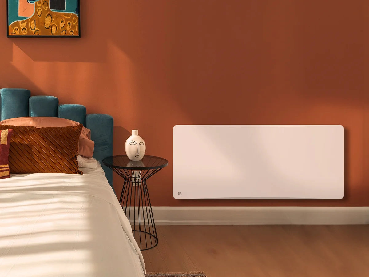 Radiador cerámico de inercia seca con termostato intercambiable OVEO en un dormitorio acogedor
