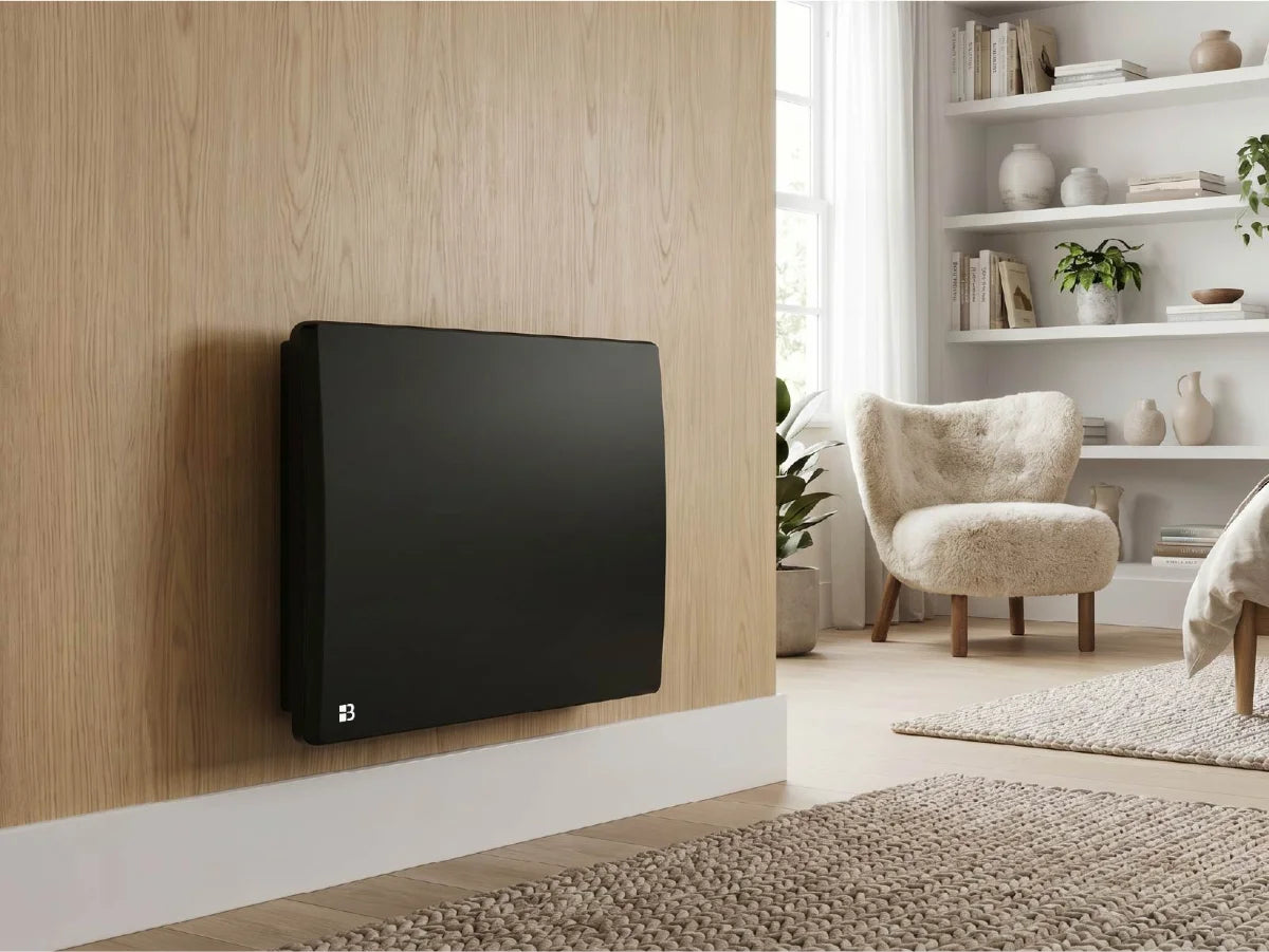 ARIA BLACK ceramic dry inertia radiator in a modern, bright living room