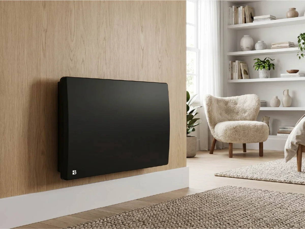ARIA BLACK ceramic dry inertia radiator in a modern, bright living room