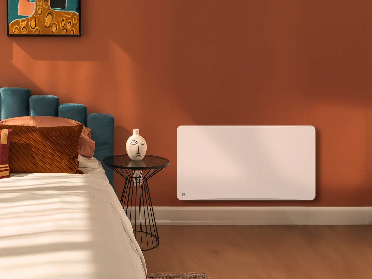 Radiador cerámico de inercia seca con termostato intercambiable OVEO en un dormitorio acogedor
